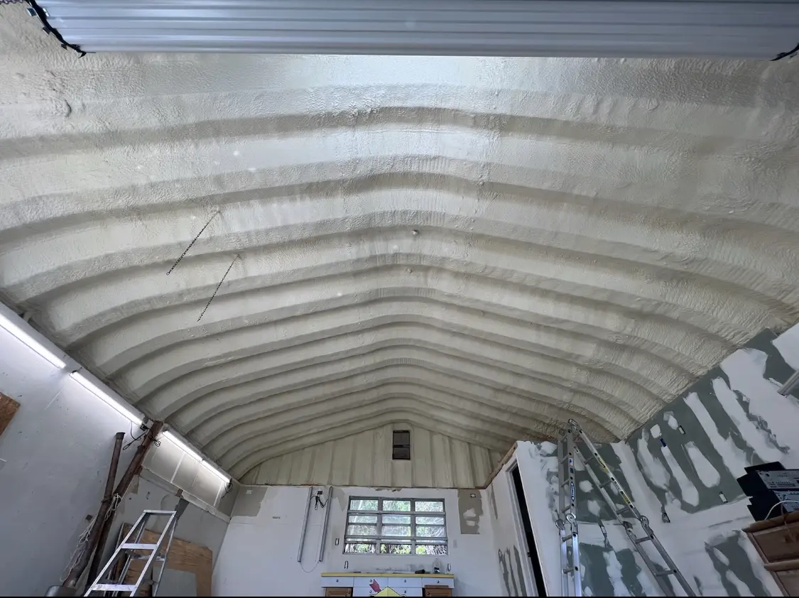 Spray polyurethane foam applied to the underside of a metal roof deck in Wilmer